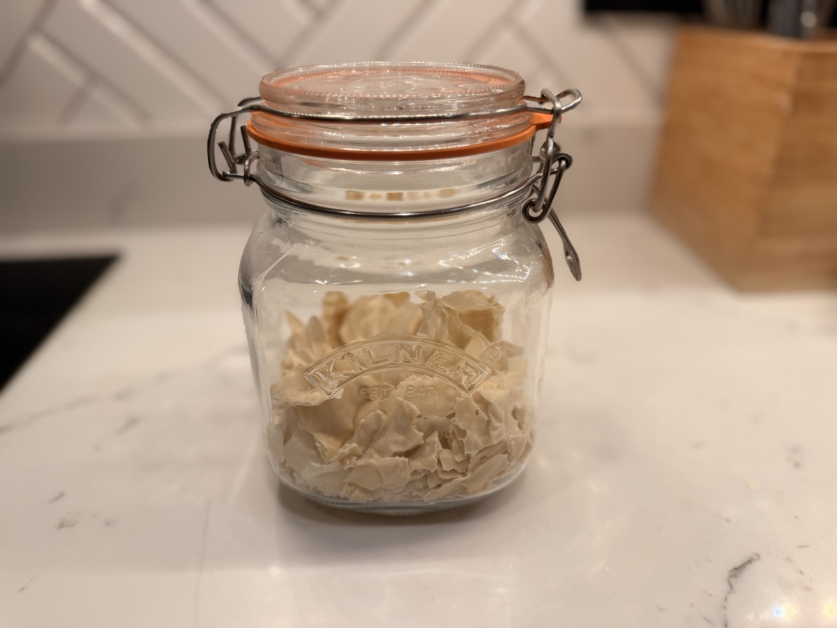 Dried sourdough starter flakes in a Kilner jar
