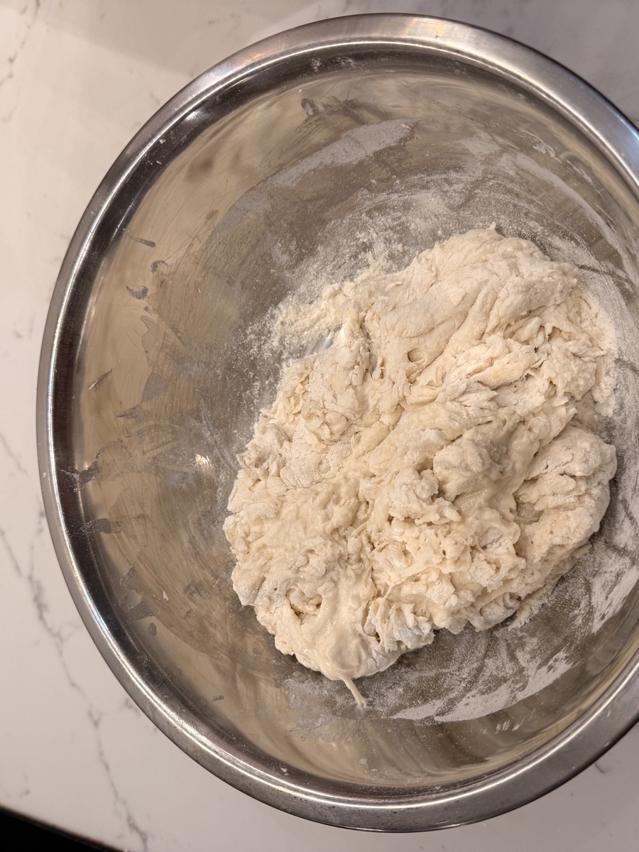 Shaggy dough showing rough, uneven texture with no dry flour visible